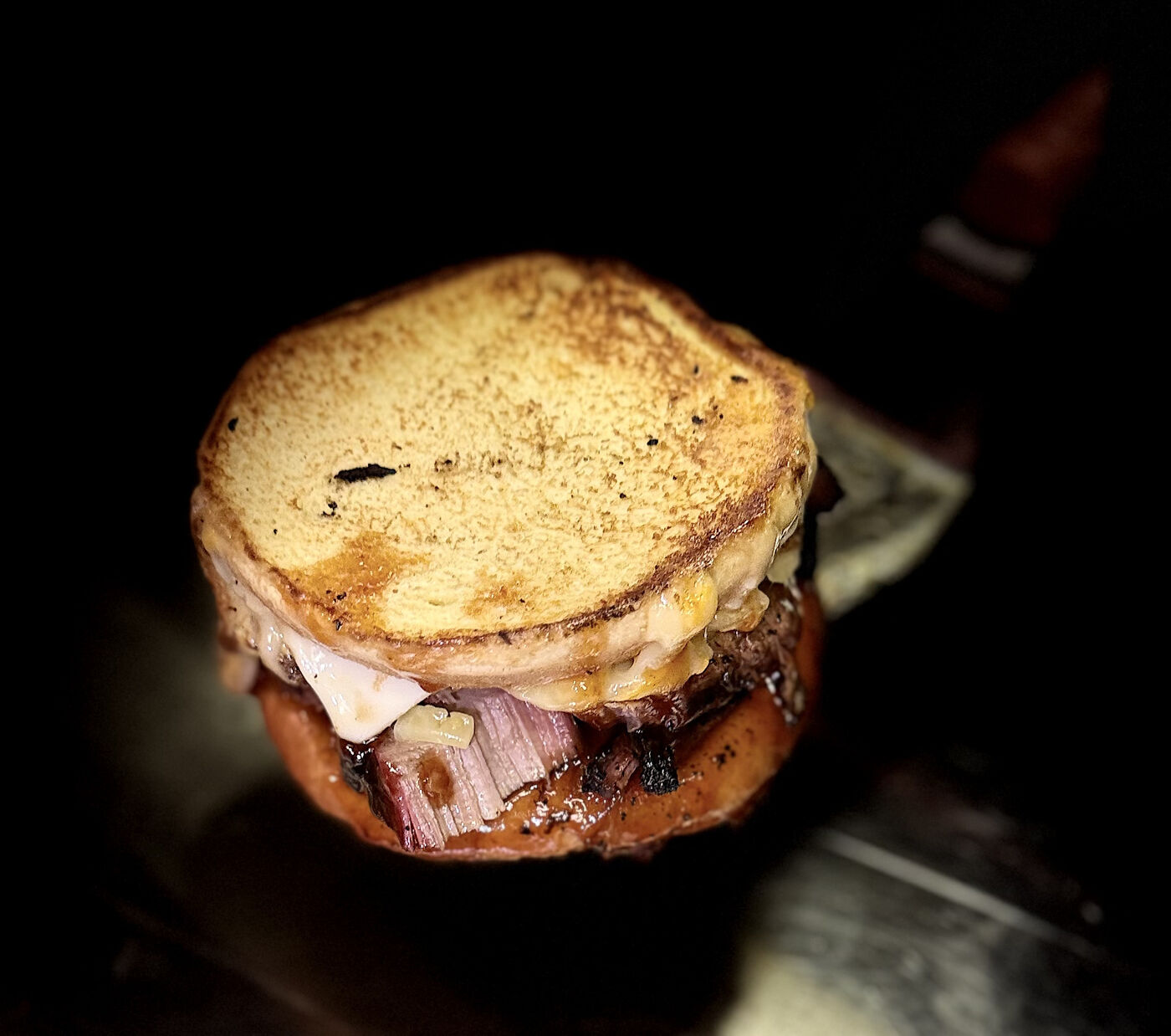 Grilled Cheese Deluxe with Brisket | Slap Yo Self BBQ — Marion, Ohio Brisket grilled cheese deluxe — slow-smoked brisket layered between griddled golden bread with melted gooey cheese at Slap Yo Self BBQ in Marion, Ohio